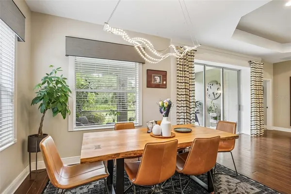 a view of a dining room with furniture window and wooden floor