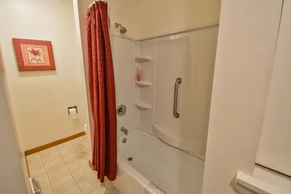 a bathroom with a sink and mirror with toilet