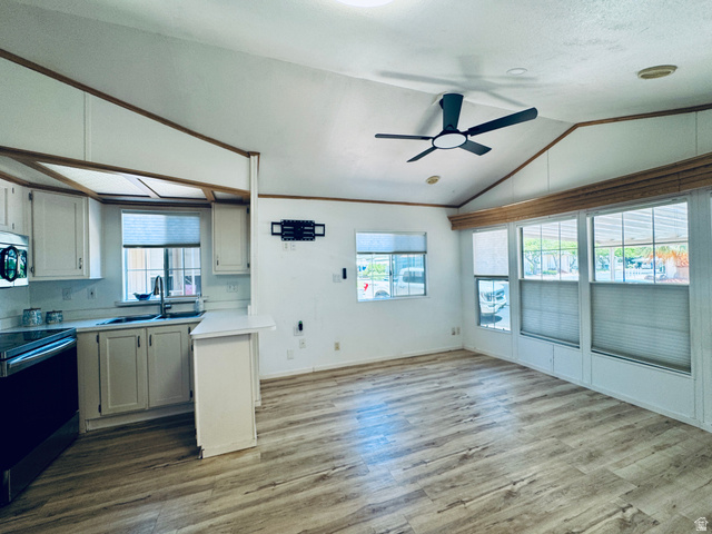 150 North 3050 East, Unit 4 St. George, UT 84790 - Photo 8 of 24 Open-concept living space featuring wood-finish flooring, vaulted ceilings, and a contemporary ceiling fan