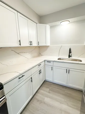 a kitchen with a sink and cabinets