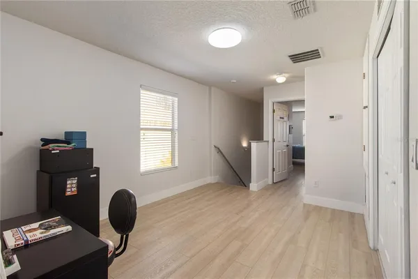 a view of workspace with wooden floor and windows