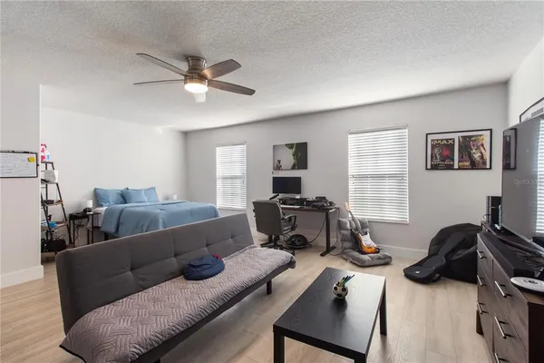 a living room with furniture ceiling fan and a window
