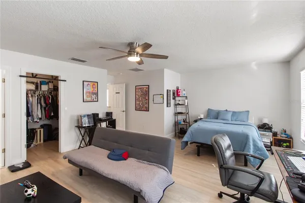 a bedroom with furniture and a chandelier