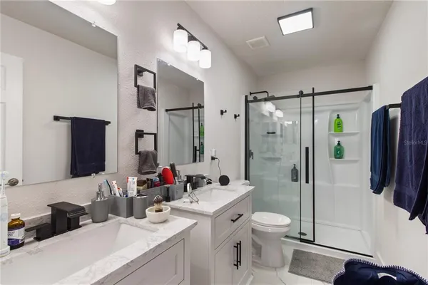 a bathroom with a sink toilet tub and shower