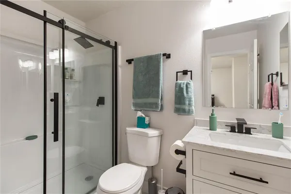 a bathroom with a toilet sink and shower