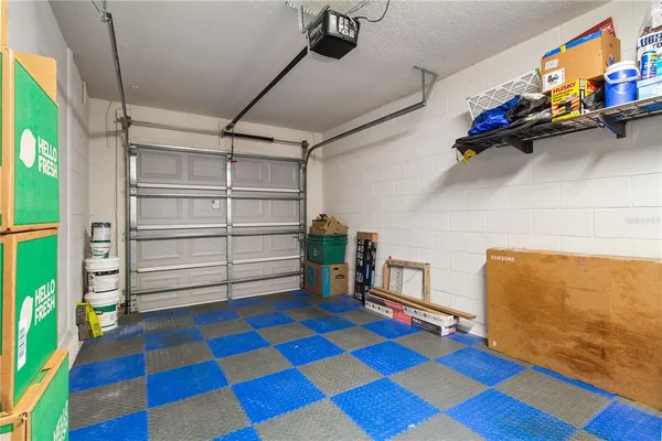 a room with lots of white furniture and wooden floor