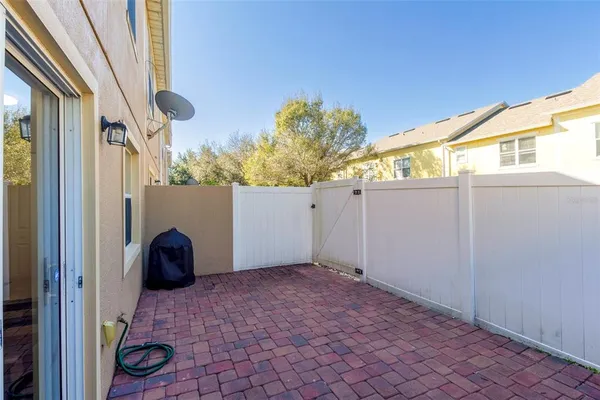 a view of backyard with wheel chair and wooden fence