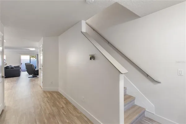 a view of entryway and hall with wooden floor