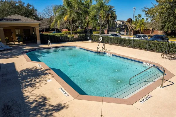 a view of swimming pool with a table and chairs