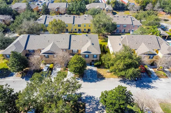 an aerial view of a house with a swimming pool outdoor seating and yard