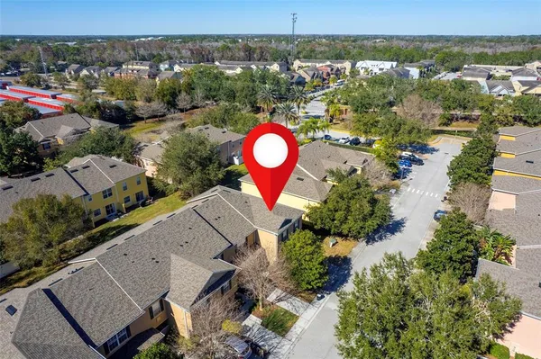 an aerial view of lake and residential houses with outdoor space