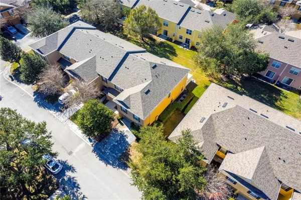 an aerial view of a swimming pool with outdoor seating