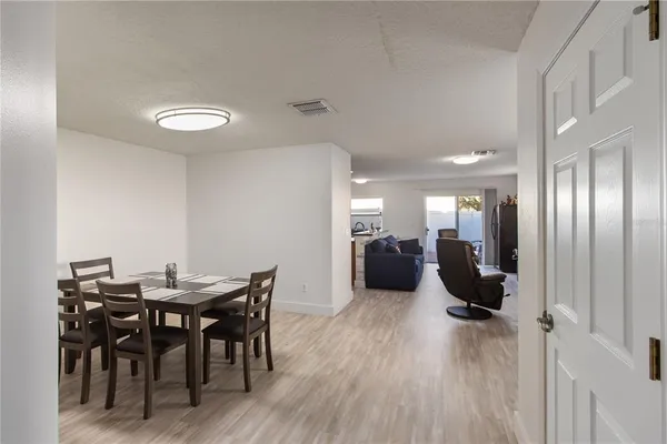 a view of a a dining room with furniture and wooden floor