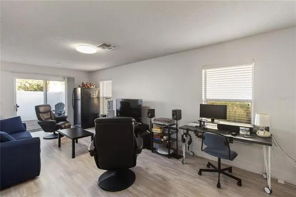 a view of a livingroom with workspace and a window