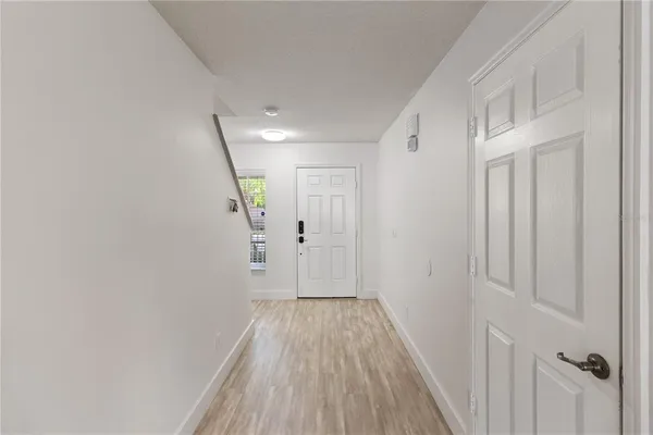 a view of a hallway with wooden floor
