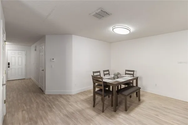 a view of a dining room with furniture and wooden floor