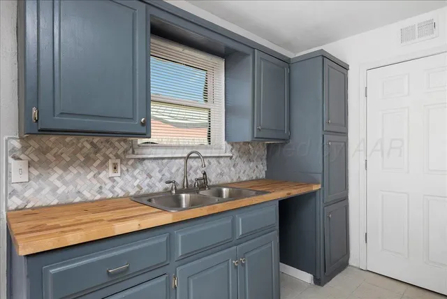 a kitchen with a sink cabinets and a window