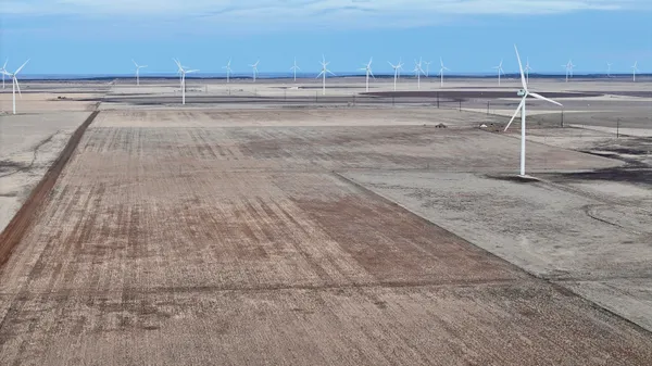 a view of a room with an empty space and wooden floor