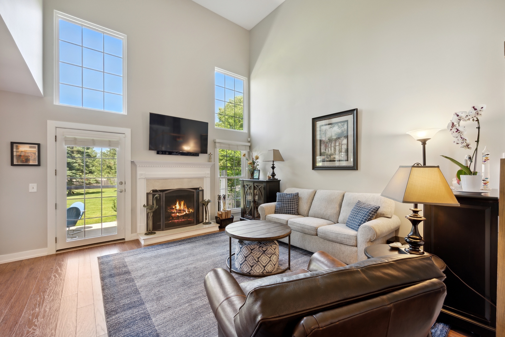 27W204 Chelsea Circle Winfield, IL 60190 - Photo 11 of 30 a living room with furniture a fireplace and a flat screen tv
