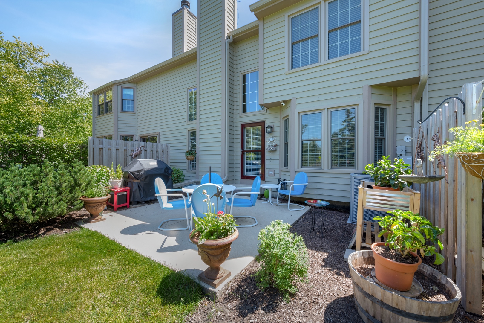27W204 Chelsea Circle Winfield, IL 60190 - Photo 24 of 30 a front view of a house with chairs and plants