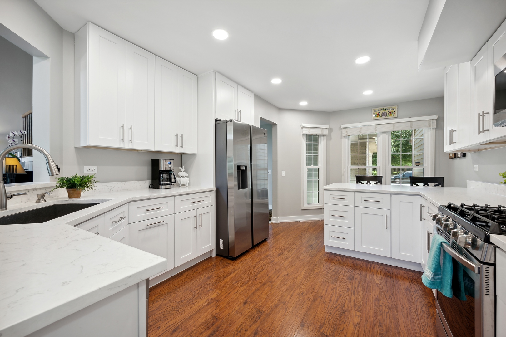 27W204 Chelsea Circle Winfield, IL 60190 - Photo 5 of 30 a kitchen with white cabinets and stainless steel appliances