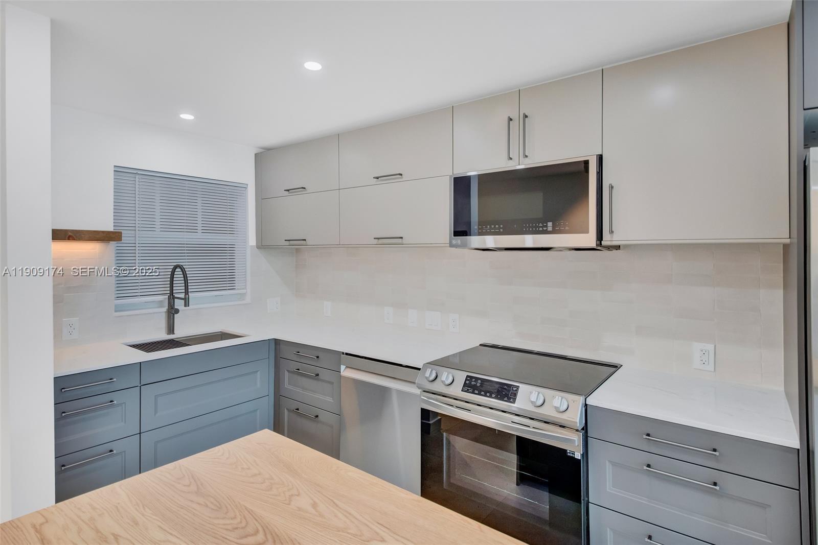 54 Isle Of Venice Drive, Unit 7 Fort Lauderdale, FL 33301 - Photo 3 of 41 a kitchen with a sink stove and microwave
