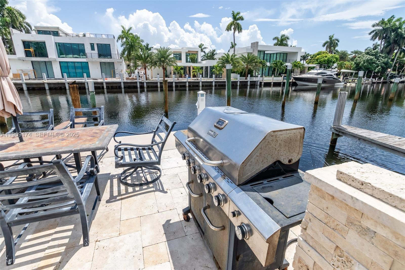 54 Isle Of Venice Drive, Unit 7 Fort Lauderdale, FL 33301 - Photo 37 of 41 a view of a lake with couches chairs and wooden floor