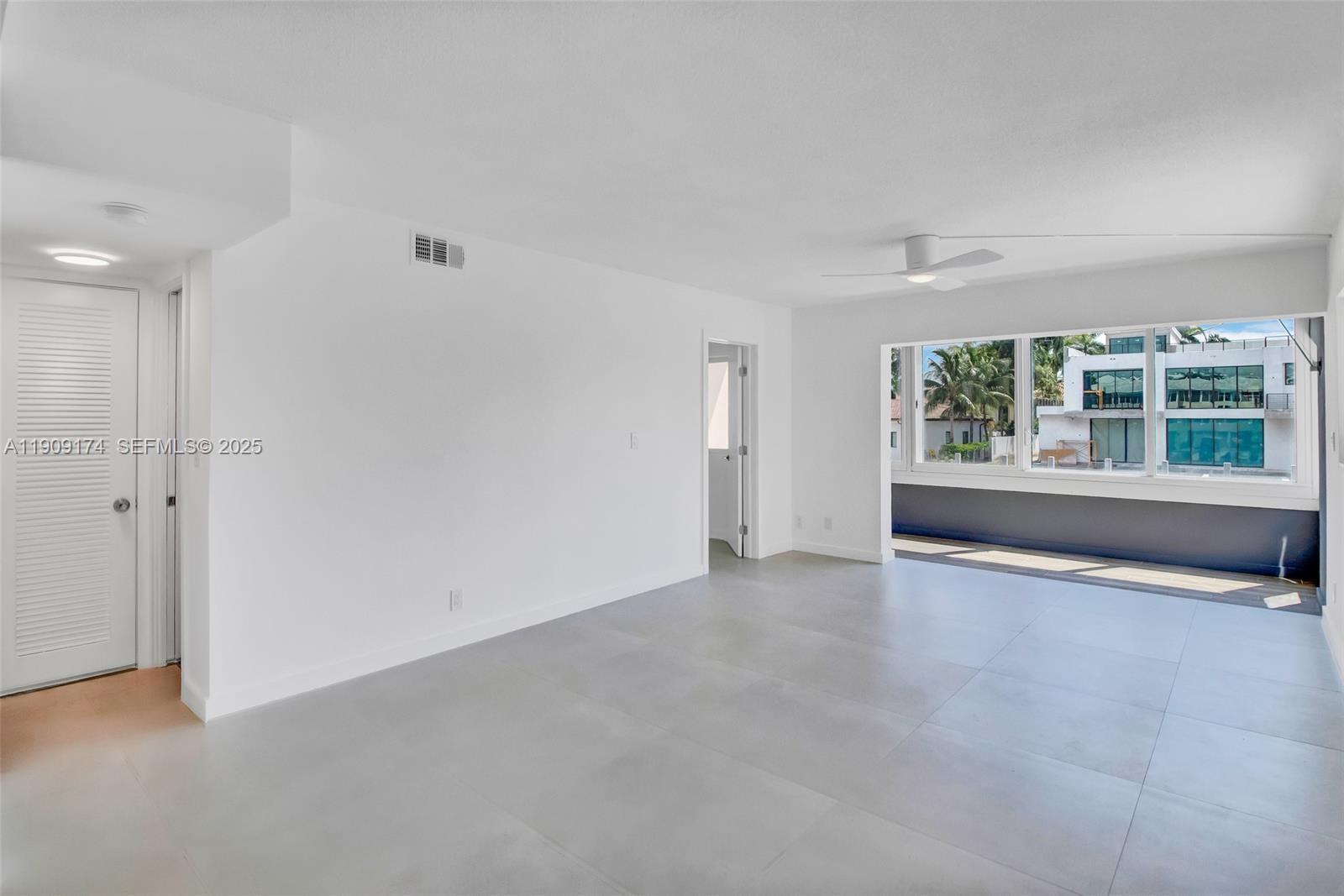 54 Isle Of Venice Drive, Unit 7 Fort Lauderdale, FL 33301 - Photo 9 of 41 an empty room with windows and entrance