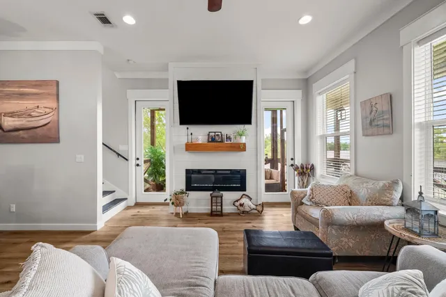 a living room with fireplace furniture and a flat screen tv