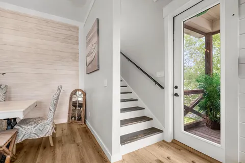 a view of entryway and hall with wooden floor