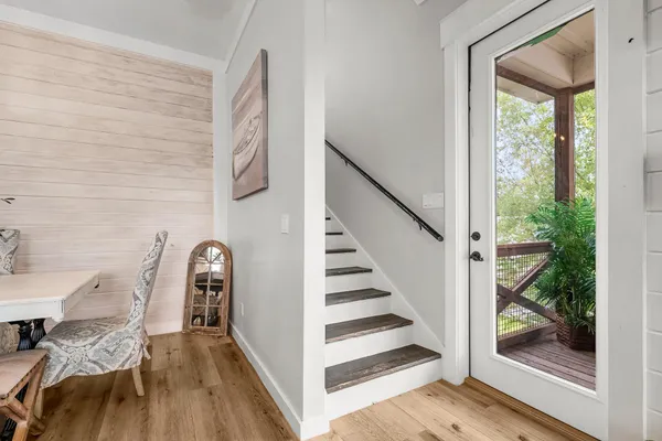 a view of entryway and hall with wooden floor
