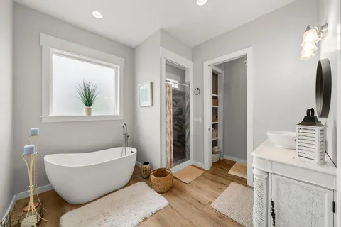 a spacious bathroom with a bathtub and sink