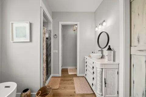 a bathroom with a sink a toilet and a mirror