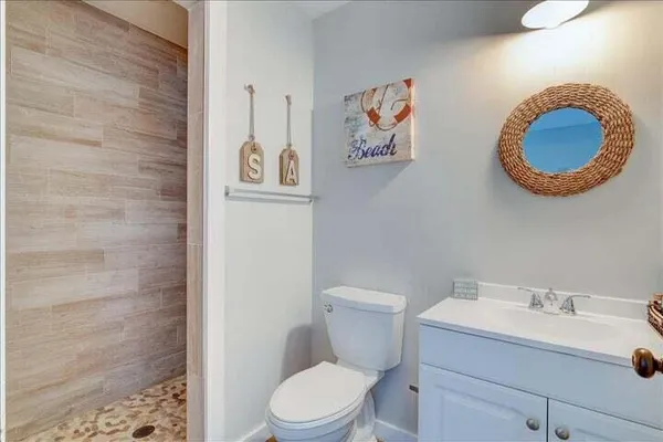 a bathroom with a toilet a sink and a mirror