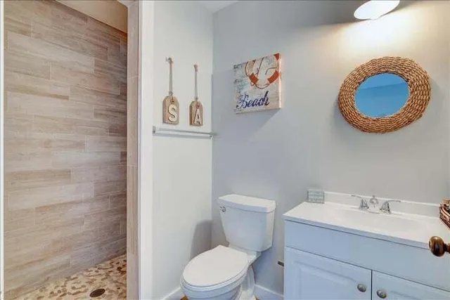 a bathroom with a toilet a sink and a mirror