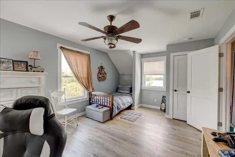 a living room with furniture a fireplace and a window