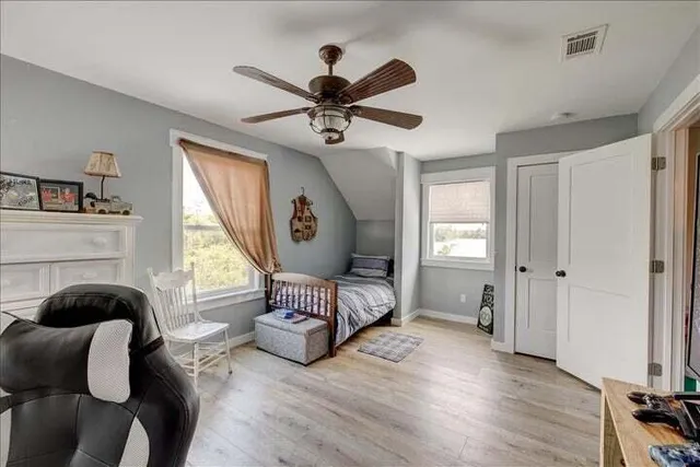 a living room with furniture a fireplace and a window