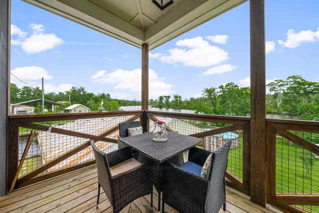 a view of a balcony with chairs and wooden floor