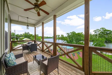 a view of a porch with furniture and wooden floor