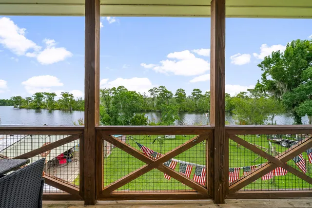 a view of a balcony with floor to ceiling windows with wooden floor