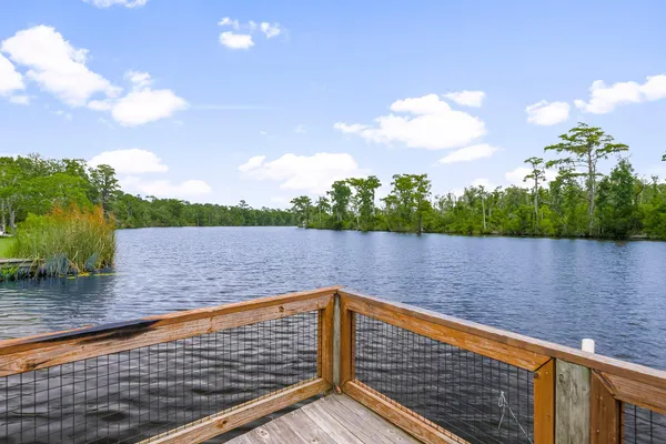 a view of a porch with furniture and a yard