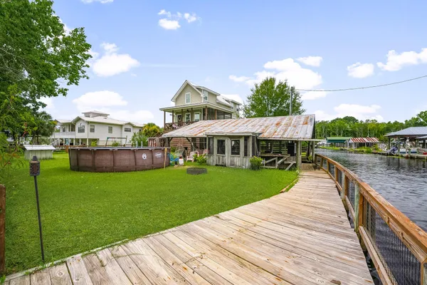 a view of a house with a yard chairs and table