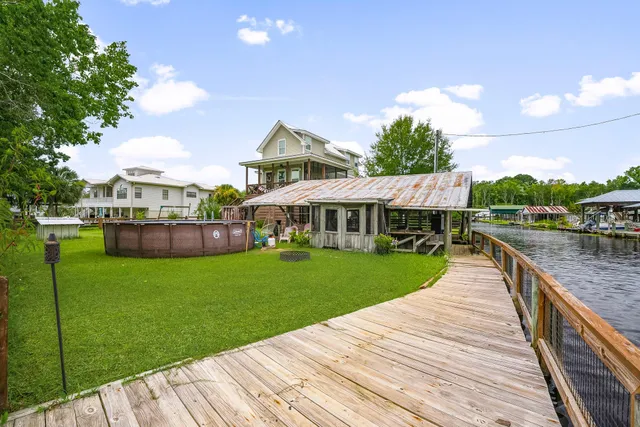 a view of a house with a yard chairs and table