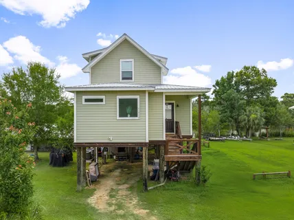 an aerial view of a house with swimming pool garden and patio