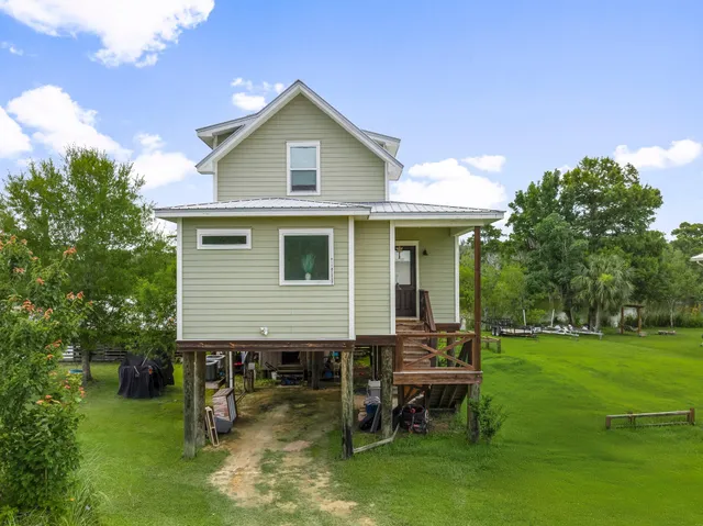 an aerial view of a house with swimming pool garden and patio