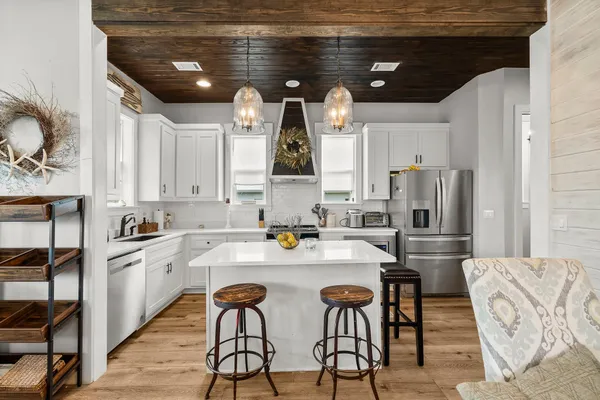 a kitchen with stainless steel appliances kitchen island granite countertop a sink and cabinets