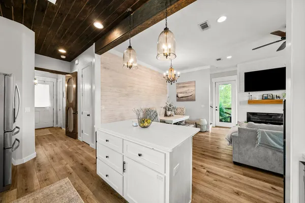 a kitchen with stainless steel appliances kitchen island granite countertop a sink and cabinets