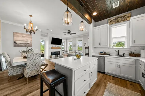 a kitchen with furniture a center island and windows
