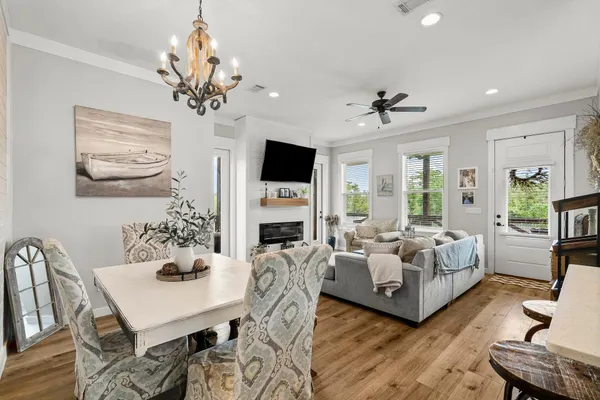 a living room with furniture a chandelier and a fireplace