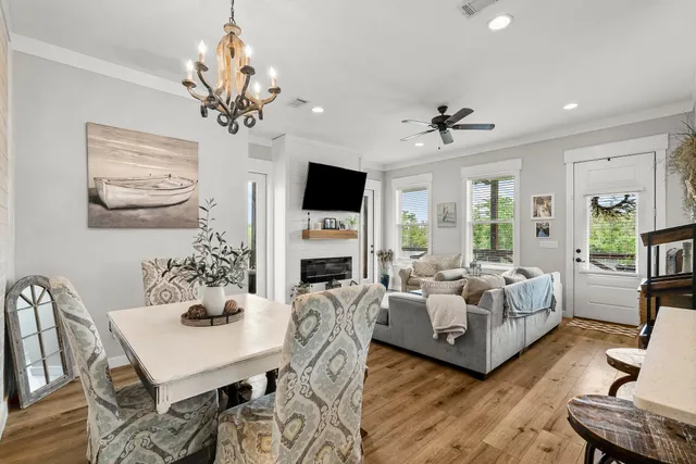 a living room with furniture a chandelier and a fireplace